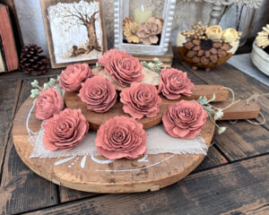 Faux wood flower blossoms hand painted in a dusty pink. Blossoms look like an English rose with layered petals with ruffles edges. 